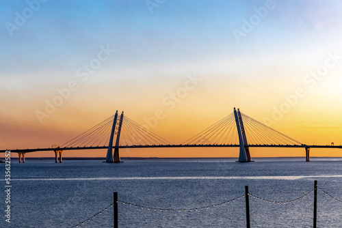 sunset on the background of the bridge and light bulbs garlands