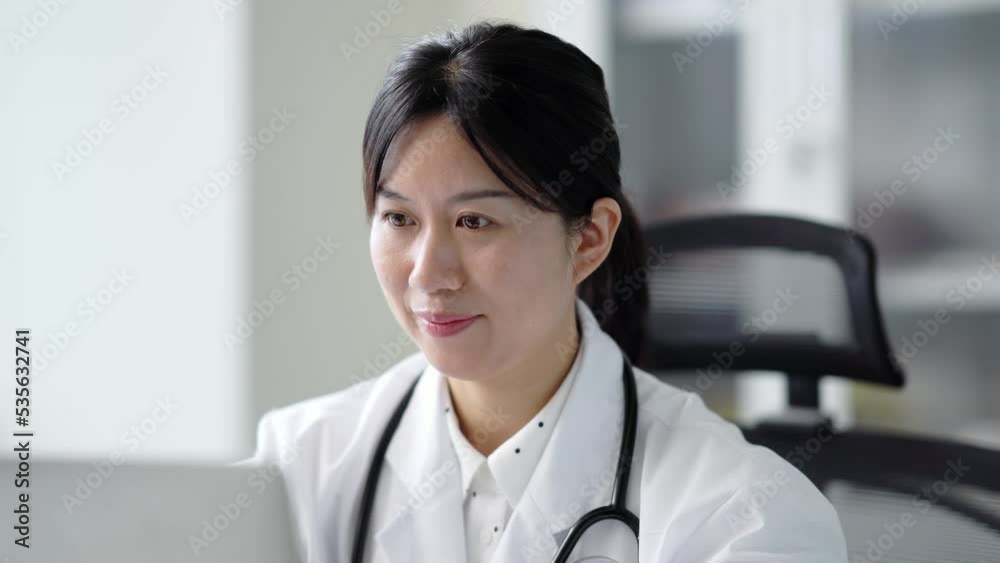 young woman doctor works with laptop in clinic young woman doctor works with laptop in clinic