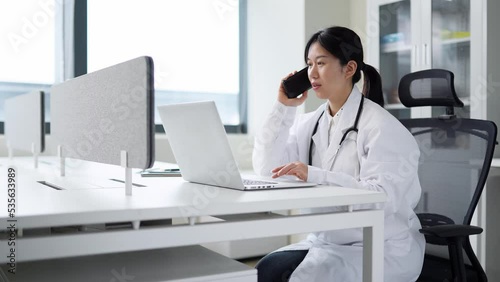 Wallpaper Mural young woman doctor works with mobile phone in clinic Torontodigital.ca