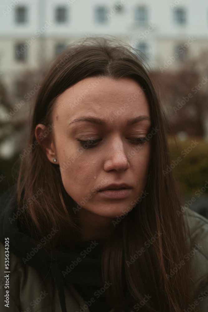 portrait of crying young woman on the street