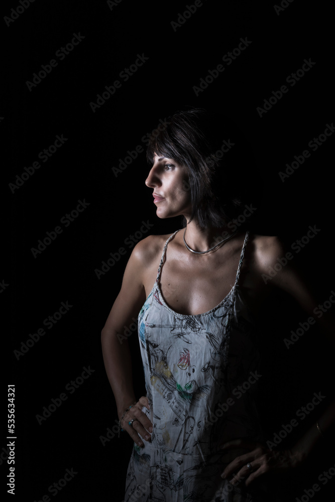 Naklejka premium young woman with black hair on black background