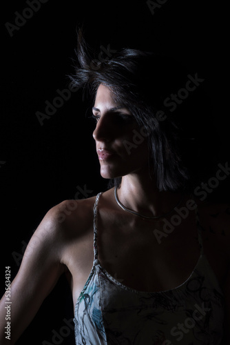 young woman with black hair on black background © fransuarez
