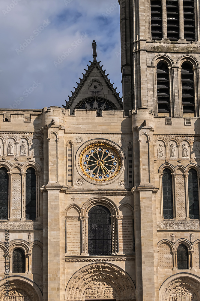 Facade of Basilica of Saint-Denis (Basilique royale de Saint-Denis, from 1144) - former medieval abbey church in city of Saint-Denis, a northern suburb of Paris. France.