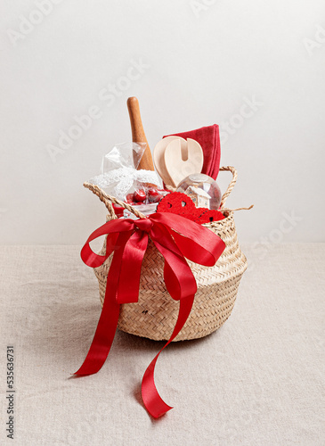 Refined Christmas gift basket for culinary enthusiats with mug, fruit tea and kitchen utensils. Corporate or personal present for cooking lovers, foodies and gourmands. photo