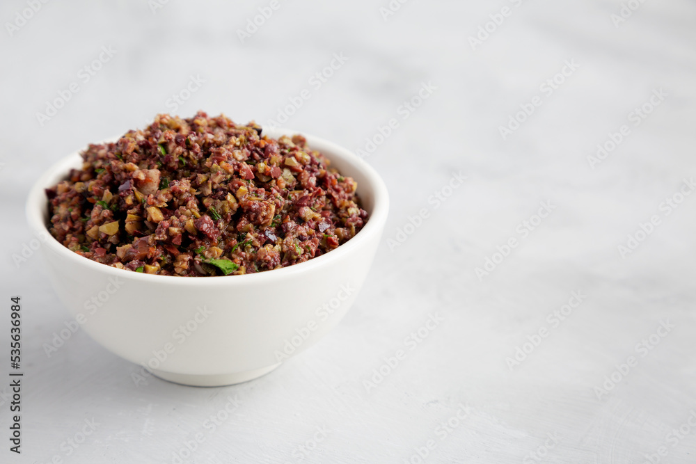 Homemade Mixed Olive Tapenade in a Bowl, side view. Space for text. Homemade Mixed Olive Tapenade in a Bowl, side view. Space for text.