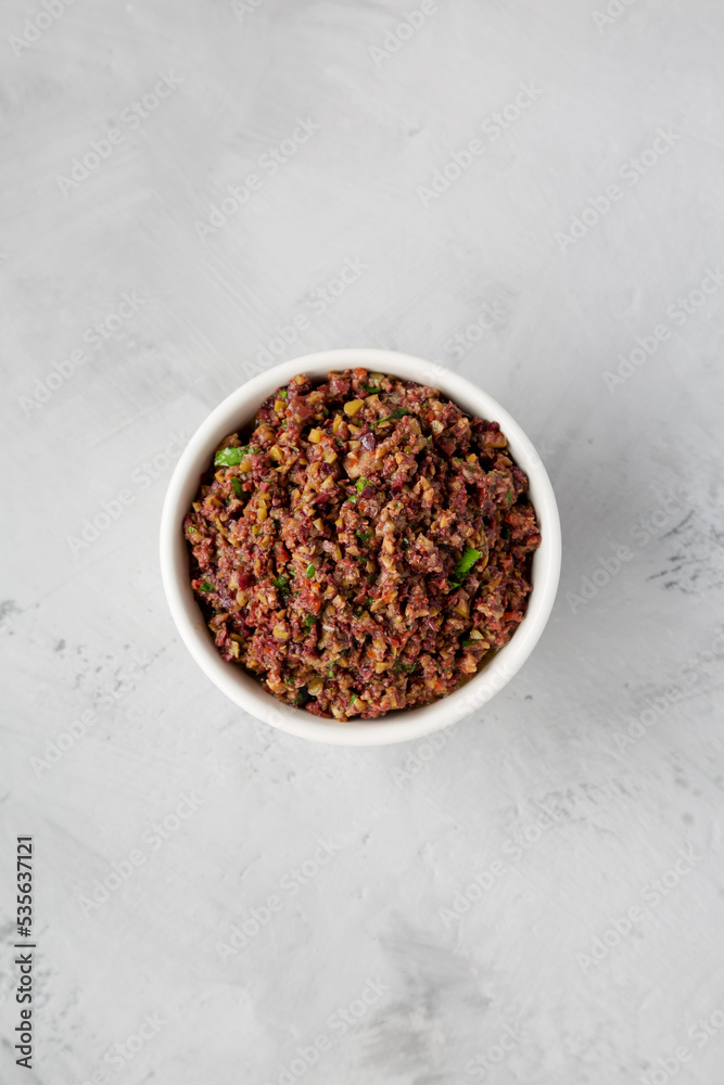 Homemade Mixed Olive Tapenade Appetizer in a Bowl, top view. Flat lay, overhead, from above. Homemade Mixed Olive Tapenade Appetizer in a Bowl, top view. Flat lay, overhead, from above.