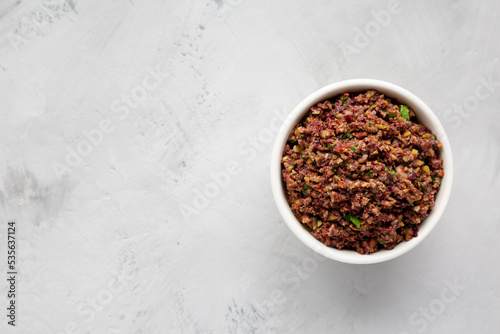 Homemade Mixed Olive Tapenade Appetizer in a Bowl, top view. Flat lay, overhead, from above. Copy space.