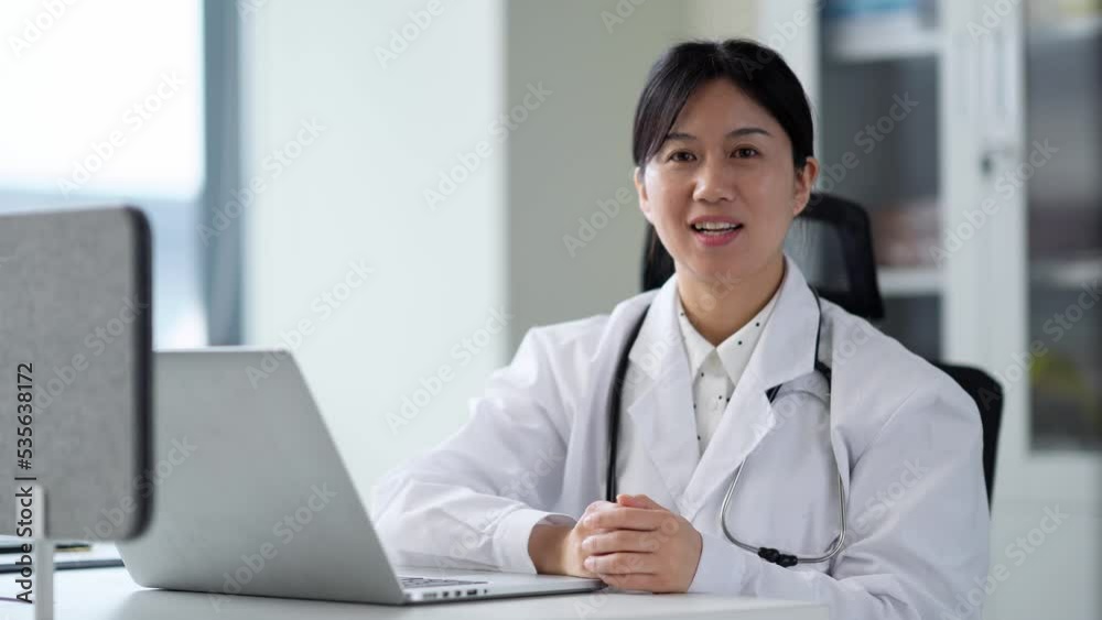 young woman doctor works with laptop in clinic young woman doctor works with laptop in clinic