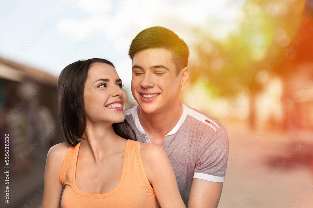 Naklejka premium Happy young couple have fun on street background