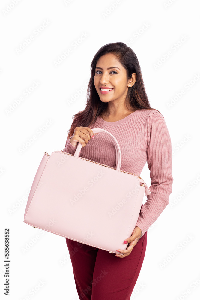 Pretty young woman showing hand bag isolated on white. Pretty young woman showing hand bag isolated on white.