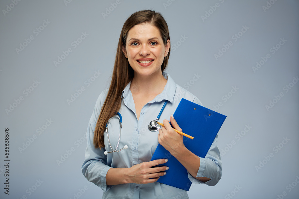 Doctor woman in medical uniform holding clipboard with health insurance. Isolated portrait of female medical worker