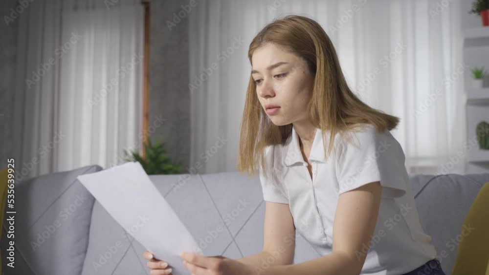 Sad devastated young woman looking at paper.
The young woman who is unhappy and saddened by the paper she is looking at.
Sad devastated young woman looking at paper.
The young woman who is unhappy and saddened by the paper she is looking at.