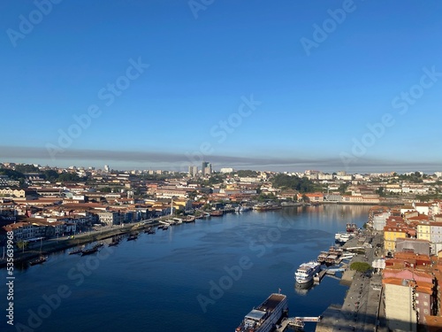 Wide Douro river with some boats sailing in a beautiful skyline from the city Porto, in Portugal © jordieasy