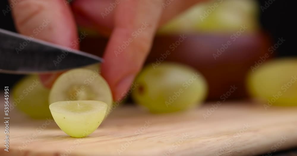 A little sluggish long - lying grapes to cut with a knife , old green grapes on the table A little sluggish long - lying grapes to cut with a knife , old green grapes on the table