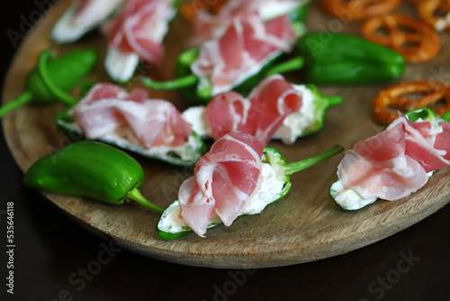 Bacon-wrapped jalapeno peppers with white cream cheese.