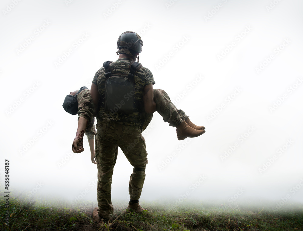 The commander carries a wounded soldier The commander carries a wounded soldier