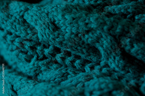 A close up of a cozy teal scarf