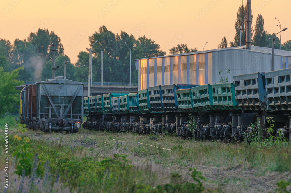 Train cargo cars, dump cars maneuvers at a railway cargo station
