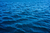 Background of a blue water surface with waves.