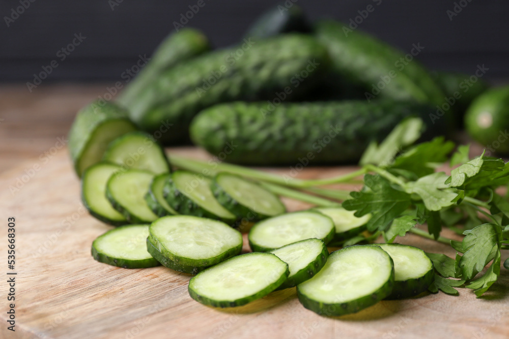 Fresh ripe cucumbers and parsley on wooden table, closeup Fresh ripe cucumbers and parsley on wooden table, closeup