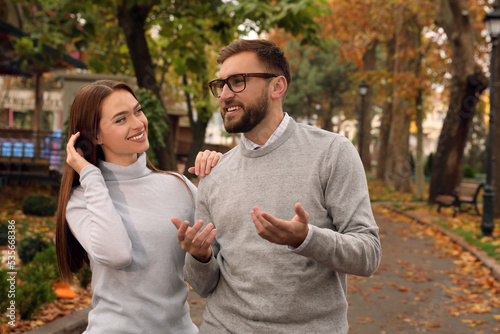 Happy couple wearing stylish clothes in autumn park