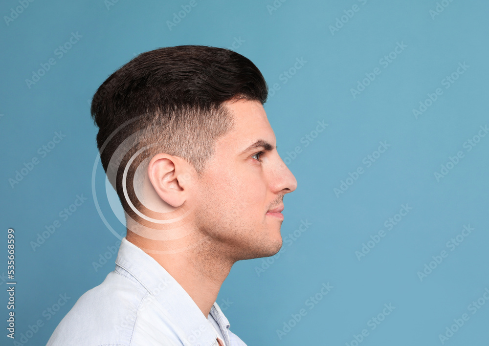 Obraz premium Hearing loss concept. Man and sound waves illustration on light blue background