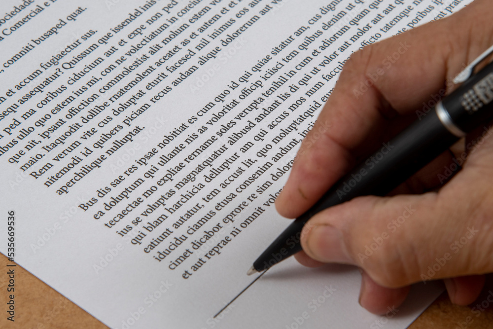 printed document signature showing a hand and ballpoint pen. printed document signature showing a hand and ballpoint pen.
