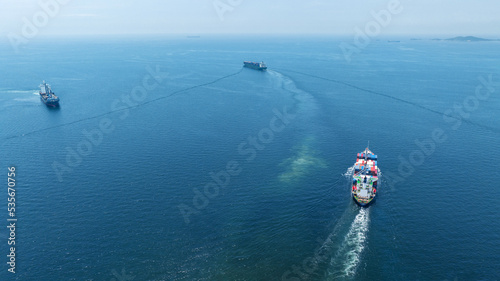 Stern of large cargo ship import export container box on the ocean sea on blue sky back ground concept transportation logistic and service to customer and supply change © Yellow Boat