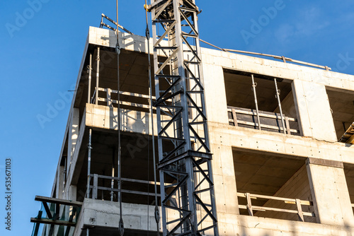 Building under construction. Construction site against blue sky. Industrial background 