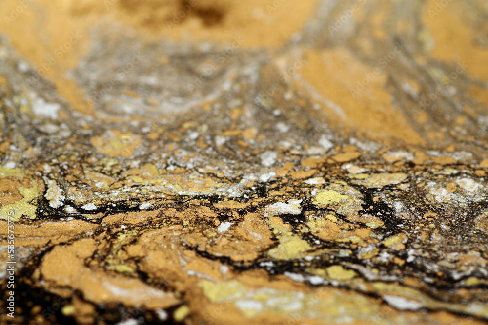 Macro shot of golden, bronze and silver particles