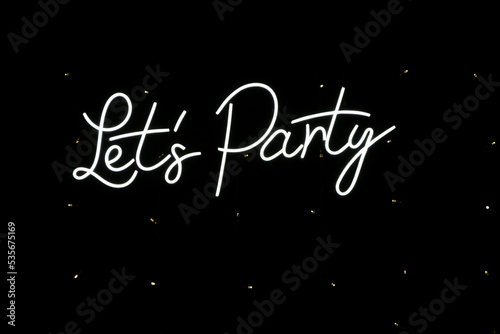 Illuminated sign on a black background with the word Let's Party