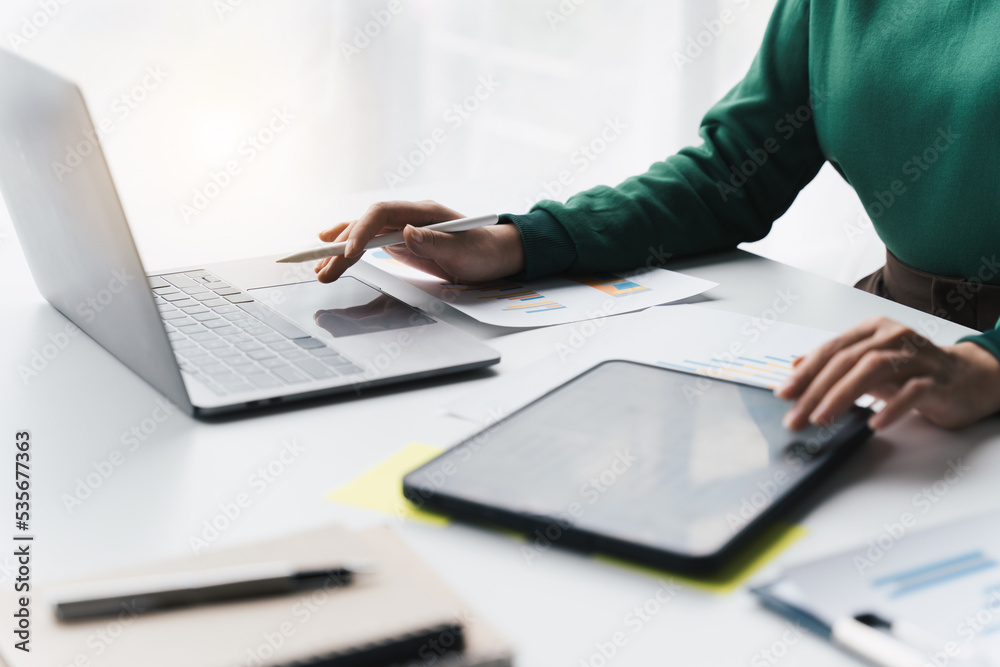 Businessman or accountant hand using laptop computer for data key and reading reports on touchpad in the office. Businessman or accountant hand using laptop computer for data key and reading reports on touchpad in the office.