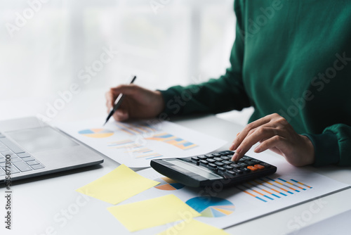 Tableau sur toile Accountant working Financial investment on calculator with calculate analyze, business data, working at office, accountancy document and laptop computer on office table
