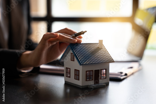Sale Estate agent are presenting home loan to customer and discussing for contract to buy, get insurance or loan real estate or property, property price concept. photo