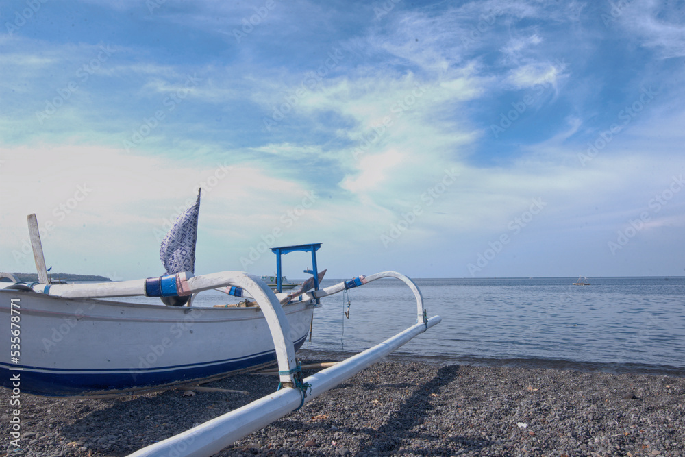 A traditional fishing boat on the sand in Amed beach, Bali, Indonesia A traditional fishing boat on the sand in Amed beach, Bali, Indonesia