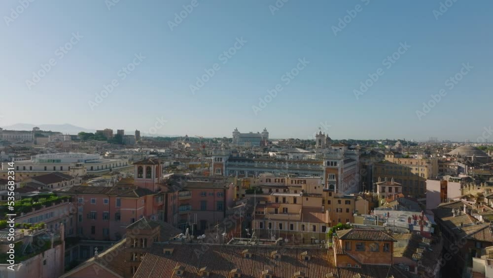 High angle view of road intersection surrounded by luxury palaces in city centre. Aerial descending footage of buildings with rooftop terraces. Rome, Italy High angle view of road intersection surrounded by luxury palaces in city centre. Aerial descending footage of buildings with rooftop terraces. Rome, Italy