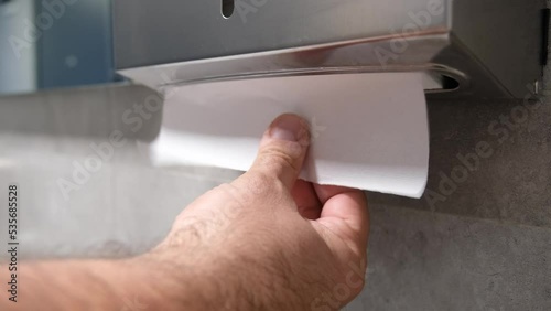 Tearing Off a Piece of Paper Towel From Roll