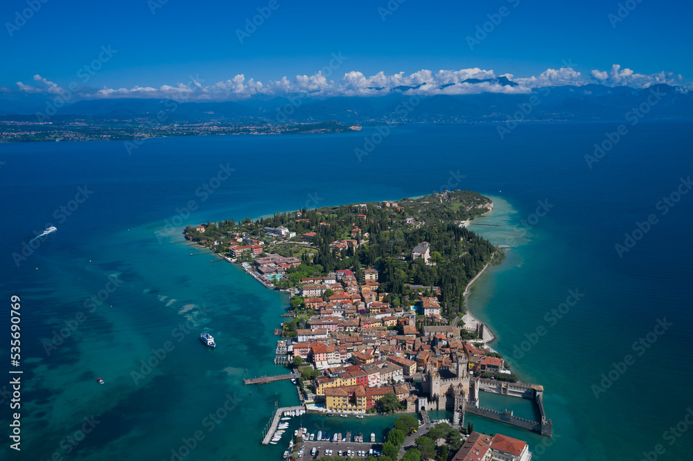 Aerial view on Sirmione sul Garda. Italy, Lombardy. Panoramic view at high altitude.  Rocca Scaligera Castle in Sirmione. Aerial photography with drone