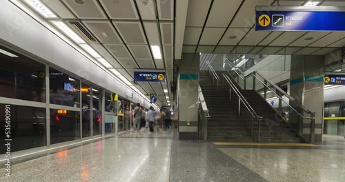 Timelapse in subway platform train station in rush hour with crowded passenger in city photo