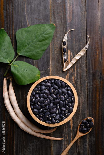 Black kidney bean seed in bowl on wooden background, Table top view