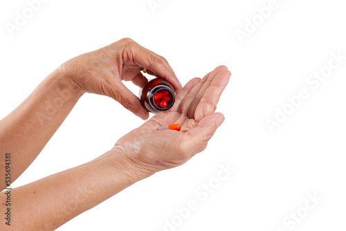 hand holding pills bottle
