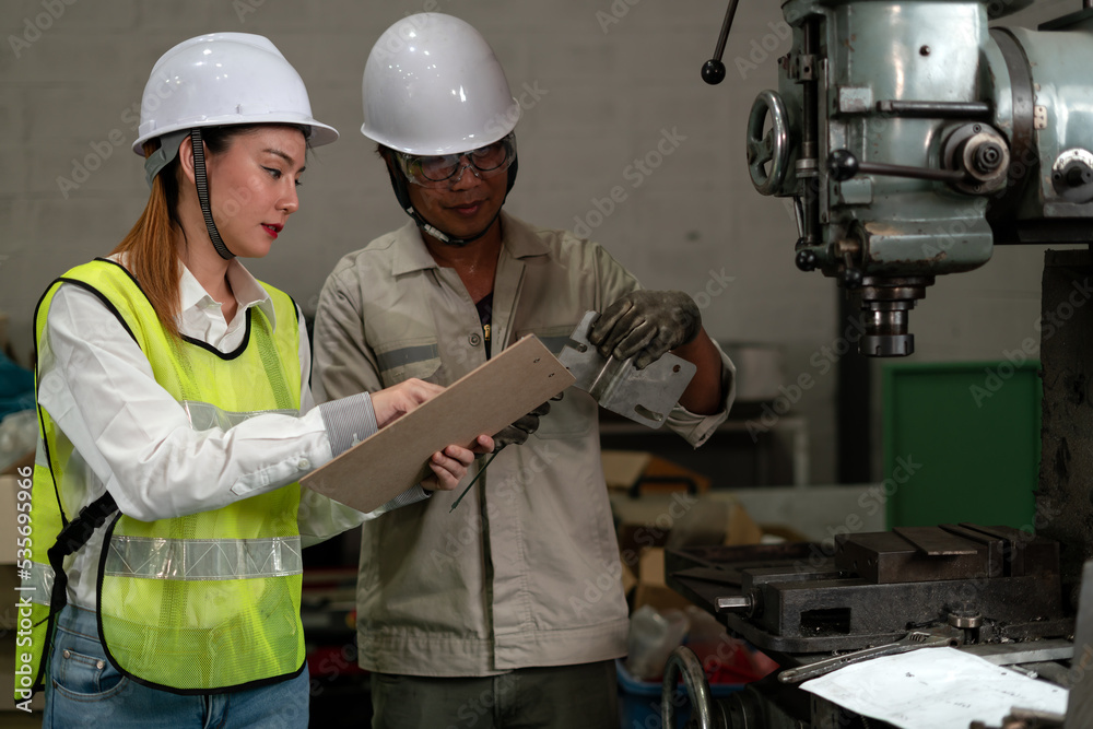 Industrial factory employee working and checking near electric meters panel of a control room in industry factory.
