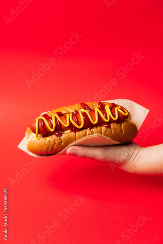 Hand holding an American Hotdog