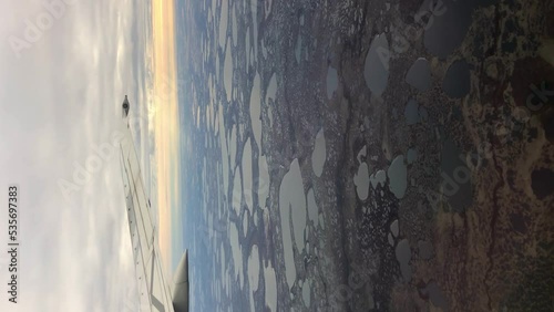 Vertical shot through airplane window of small lakes Wapusk National Park Churchill Manitoba Northern Canada photo