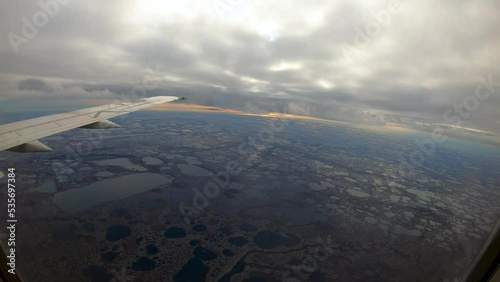 Flying through clouds to reveal Wapusk National Park flyover time lapse near Churchill Manitoba Northern Canada photo
