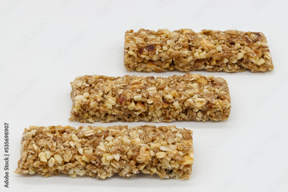 Cereal bar with apricot, apple and dried fruit on white background