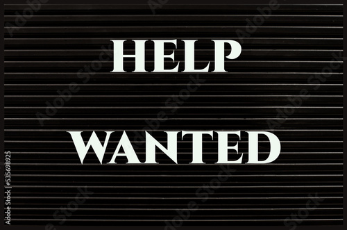 Help Wanted concept on a black board.