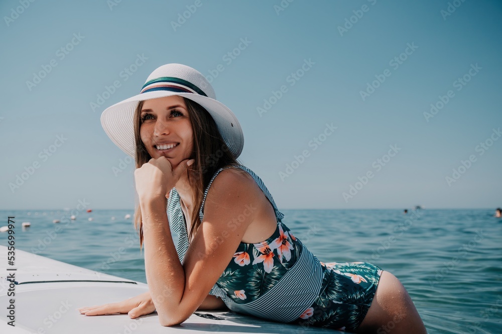 SUP Stand up paddle board. Young woman sailing on beautiful calm sea with crystal clear water. The concept of an summer holidays vacation travel, relax, active and healthy life in harmony with nature. SUP Stand up paddle board. Young woman sailing on beautiful calm sea with crystal clear water. The concept of an summer holidays vacation travel, relax, active and healthy life in harmony with nature.