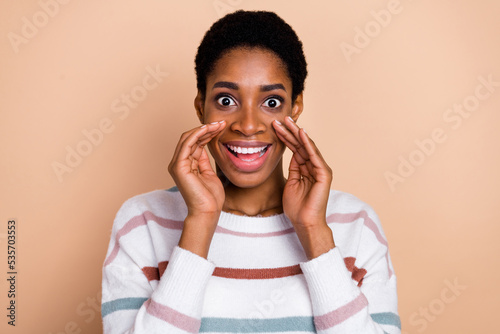 Photo of impressed millennial short hairdo lady say secret wear sweater isolated on beige color background