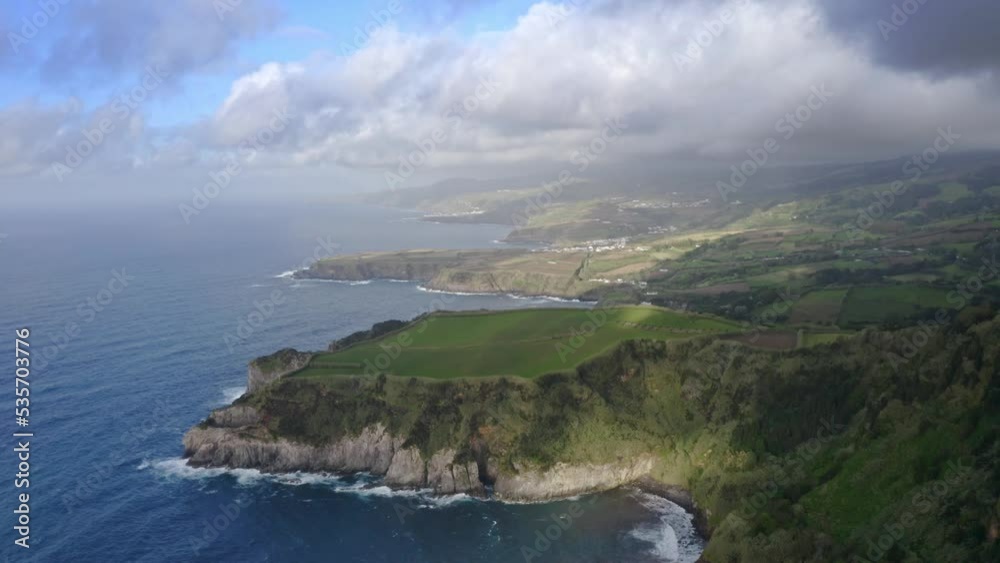 Storm clouds casting shadow on Azores coastline headlands, aerial. Storm clouds casting shadow on Azores coastline headlands, aerial.